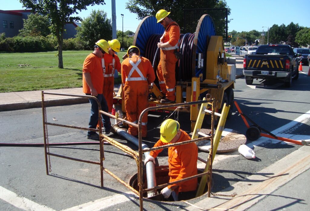 Municipal workers use zero emission power to perform work on street